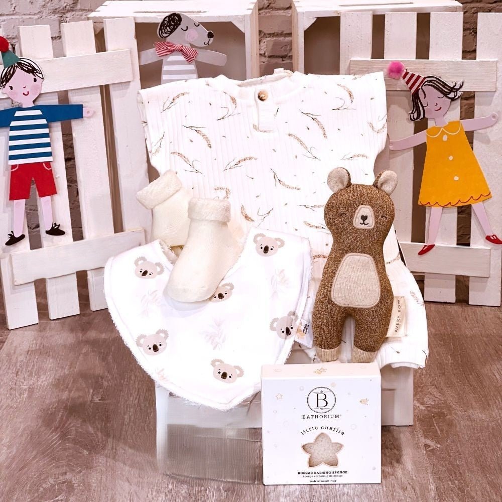 "Sweet Trésor baby gift box featuring adorable plush toy, soft baby essentials, and charming accessories."