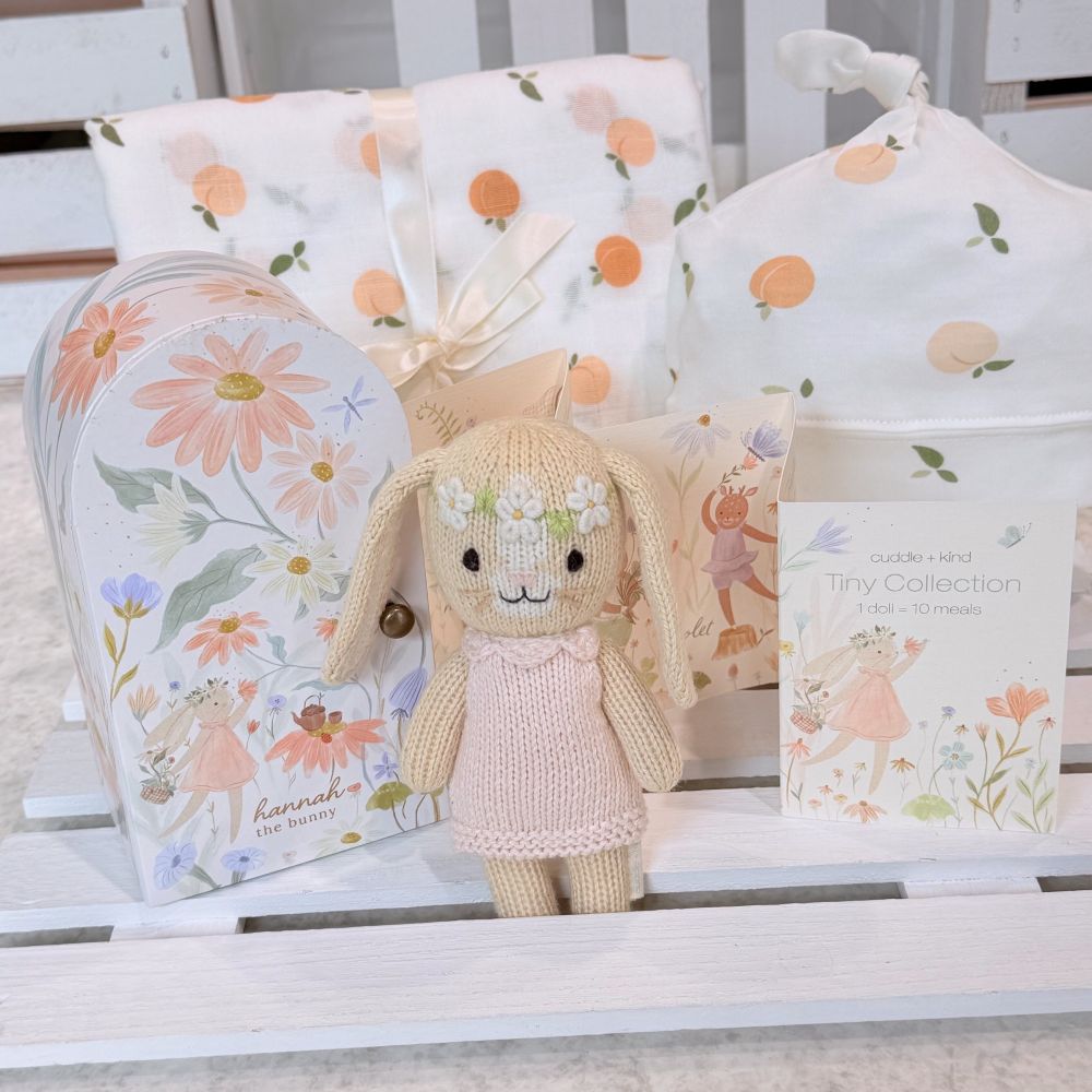 baby girl gift with cuddle and kind Hannah doll, swaddle blanket and hat set, with booties and soap and bubble bath with bamboo baja washcloth.